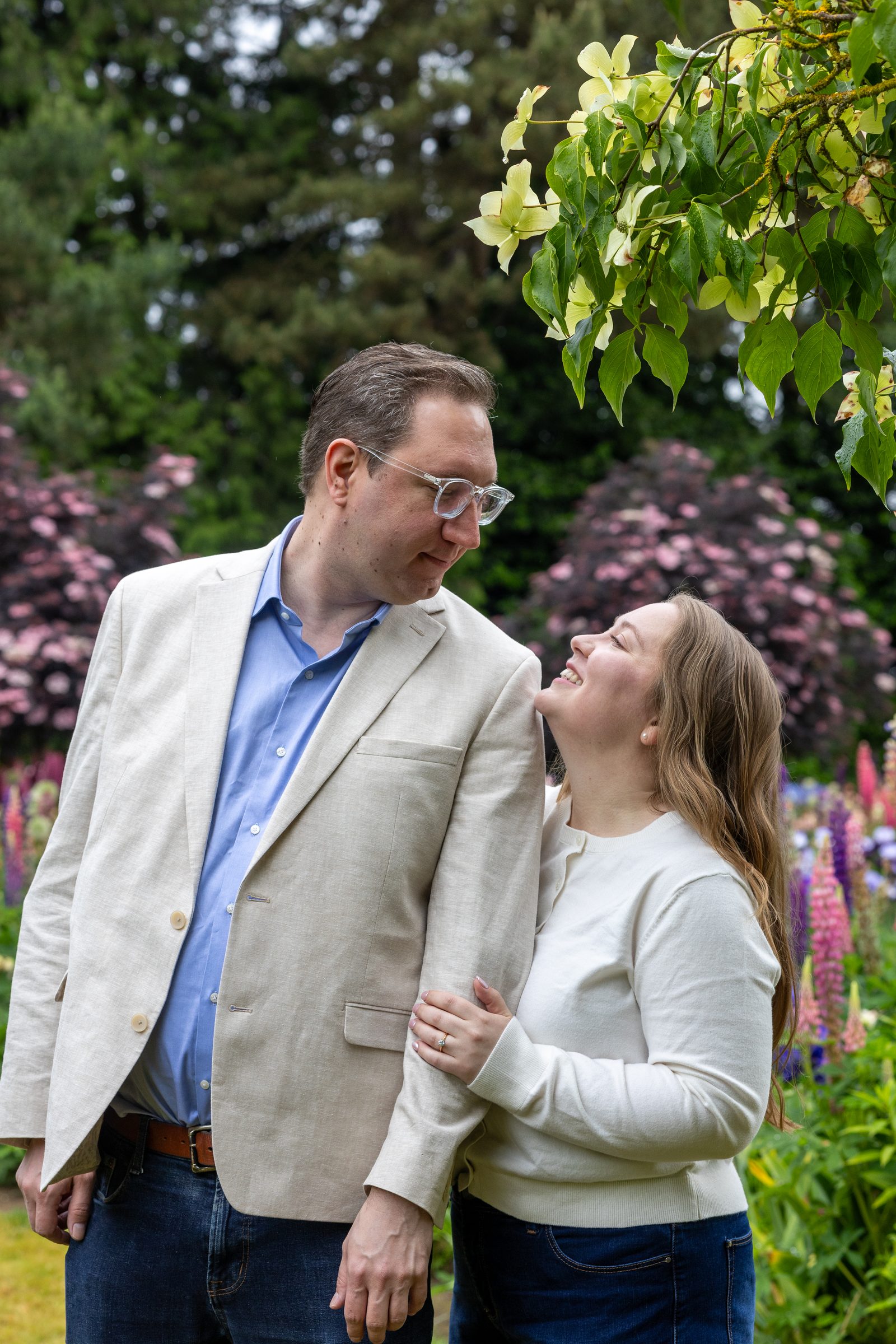 Rachel and Daniel smiling at each other in the gardens